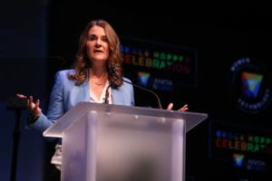 Melinda Gates stands behind a podium and talks on the main stage during the GHC 17 Wednesday Keynote