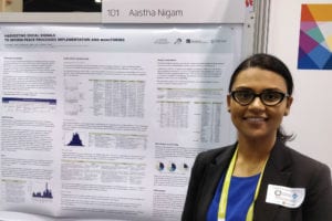 Aastha Nigam, 2nd place graduate winner of the ACM Student Research Competition, smiles as she stands by her poster at the GHC 17 Poster Session