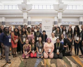 A crowd of students pose in front of the BRAID Welcome Reception sign at GHC 17