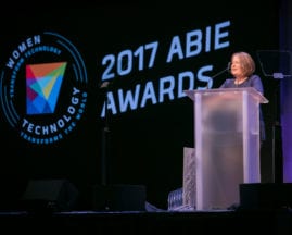ABIE Award winner Diane Greene gives her speech behind a podium on the main stage