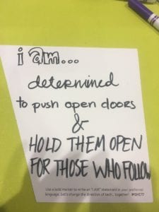 The back of Erica McDonnell's "I AM" sign, which says, "I Am determined to push open doors and hold them open for those who follow."