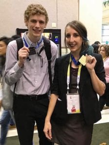 Stephanie Mason (right), 1st place undergraduate winner of the ACM Student Research Competition. and Theodore Weber (left), the 2nd place undergraduate winner, wear and hold up their medals